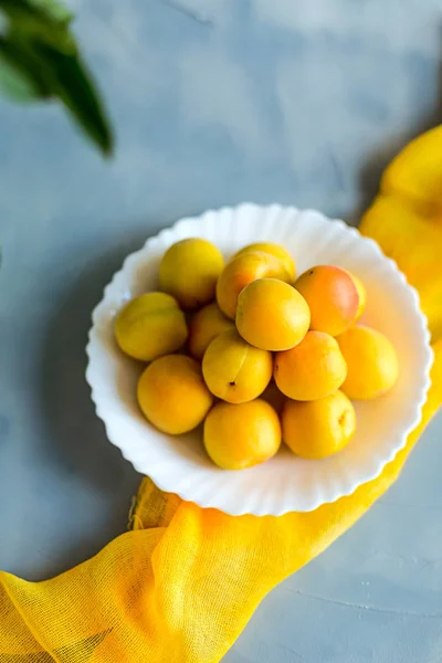 Fresh and ripe apricots on grey background. Season berries, summ — Stock Photo, Image