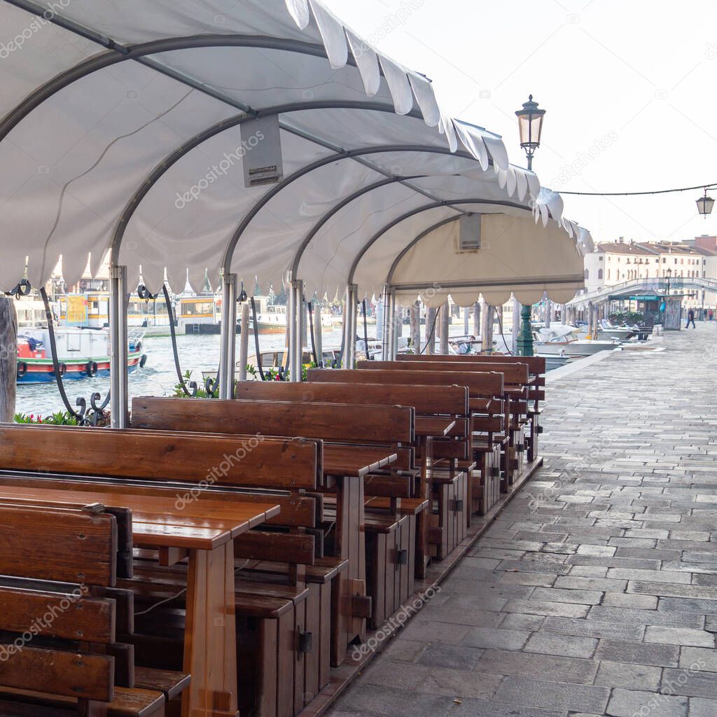 Venice, Italy. Empty tables in a street cafe