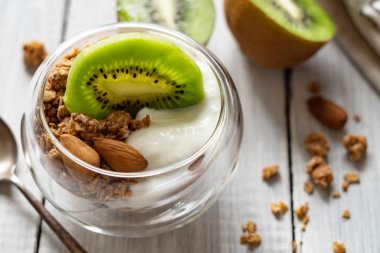 Healthy organic light breakfast. Cereal granola, yogurt and kiwi