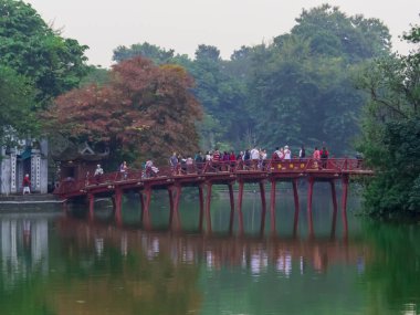 Hanoi, Vietnam - 19 Aralık 2019: Hoan Kiem Gölü 'ndeki ünlü Kızıl Köprü' deki insanlar.