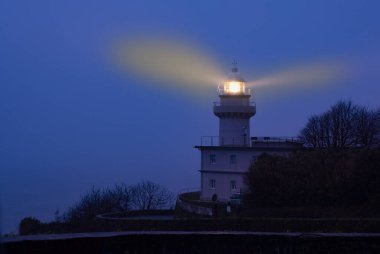 Lights in the lighthouse with fog at dawn, Igueldo, city of Donostia (San Sebastian) clipart