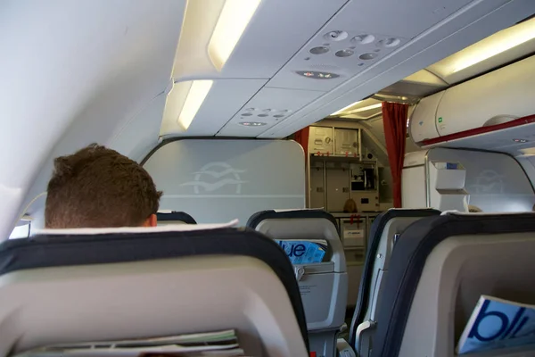 THESSALONIKI, GREECE - OCTOBER 15, 2016: Airplane cabin, business class interior seats, passenger after takeoff — Stock Photo, Image