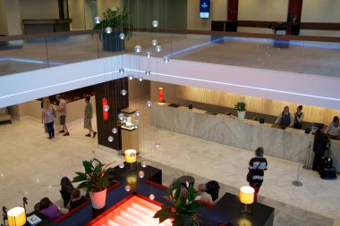 Mainz, Almanya - 8 Temmuz 2017: Modern iç mekanları, Hilton Mainz otel lobisinin sırada bekleyen insan ile