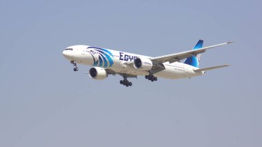 DUBAI, UNITED ARAB EMIRATES - APRIL 1st, 2014: Boeing 777-300ER from Egypt Air on final approach to Dubai Airport DXB registration SU-GDR, Egypt Air is Africas largest airline operating passenger clipart