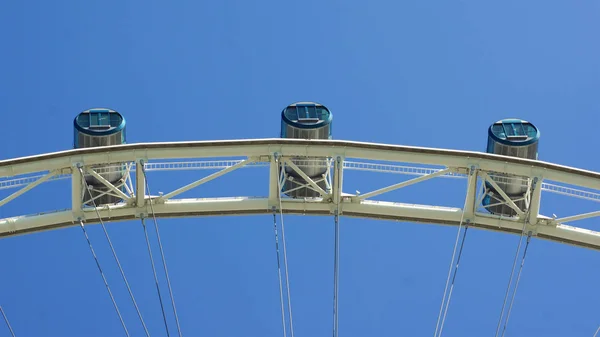 SINGAPORE - APR 2nd, 2015: The top of Singapore flyers cabin with cloudy sky background. It is a giant Ferris wheel in modern city. — Stock Photo, Image