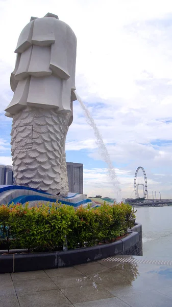 Singapur - 2 duben 2015: The Merlion fontány a panoráma Singapuru. Merlion je mytologická bytost s hlavou lva a těla ryby. Je považováno za symbol města — Stock fotografie