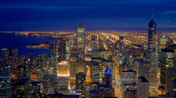 CHICAGO, ILLINOIS, UNITED STATES - DEC 11th, 2015: Aerial view of Chicago downtown at night from John Hancock skyscraper high above.