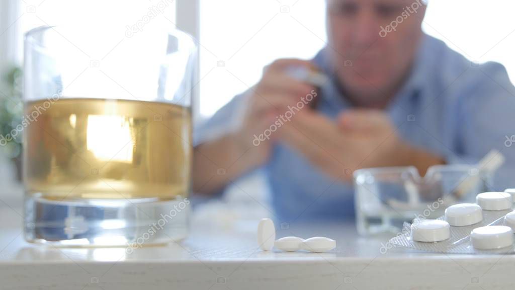 Image with a Man Mixing Alcohol Medical Pills and Cigarettes