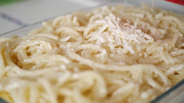 A Man in the Kitchen Prepares a Tray with Macaroni and Grate Cheese — 비디오