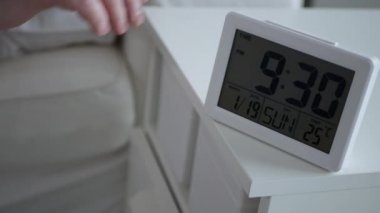 Dizzy Man Wakes Up from Sleep Sets Off the Clock Alarm and Check the Time