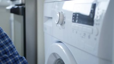 Man Close the Laundry Machine Front Door Set the Program and Push Start Button