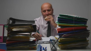 Starved Businessman  Working with Files in Archive Room Eating a Tasty Sandwich