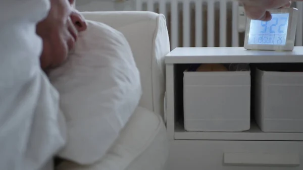 Elderly Person Wakes Up from Sleep and Set Off the Alarm Clock from the Nightstand — 스톡 사진