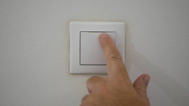 Businessman Hand Pushing the Light Switch from Office Room Wall, Man Starting the Light in a Room