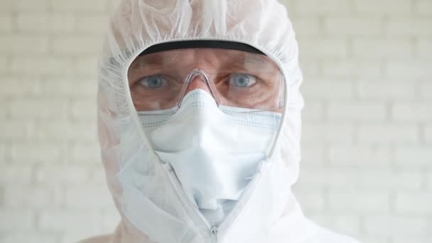 Slow Motion with a Doctor Wearing Protection Suit, Mask, Gloves, and Eyeglasses in a Hospital Quarantine for an Epidemic Crisis — Stock Video