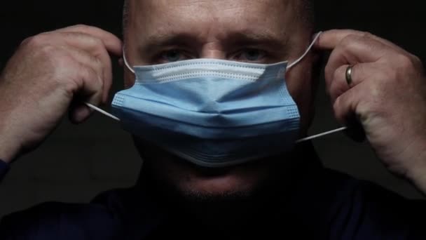 Slow Motion with Doctor Nearing Protective Face Mask, Medical Person with Protection Equipment in a Quarantined Hospital against Virus Epidemic — Wideo stockowe