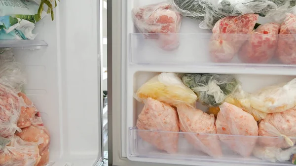 Freezer Filled with Meat and Vegetable Packets Frozen in Plastic Bags Food Reserve Stored for Food Preparation