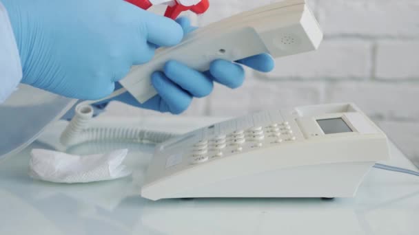 Man with Protection Gloves in Hands Cleaning and Disinfecting a Telephone Using a Spray and Wet Wipes — Stock Video