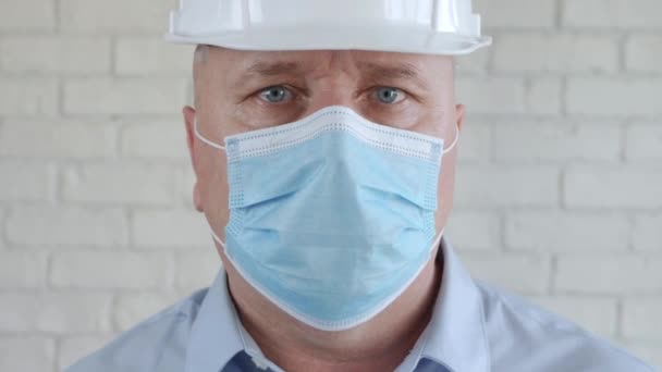 Engineer Wearing a Protective Mask Takes Off His Helmet and Wipes His Sweat on His Forehead with His Hand — Stock Video