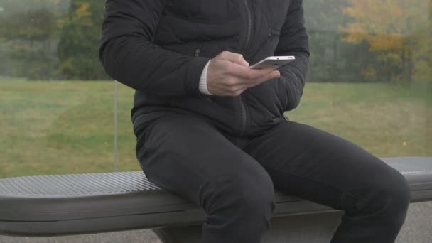 Close-up of a man using smart phone at a footbrigde — Αρχείο Βίντεο