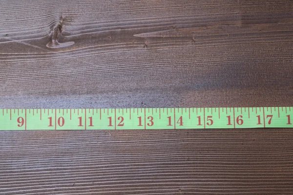 Measuring tape on wooden table — Stock Photo, Image