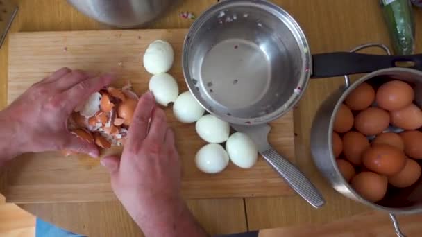 Cleaning the eggshell from the table into a metal cup — Stock Video