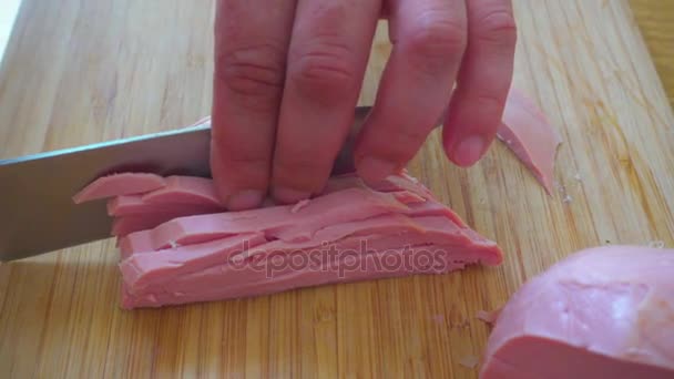 Slicing sausages into small pieces for okroshki. — Stock Video