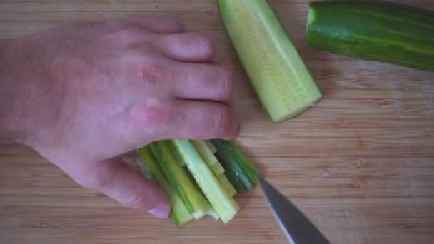 Slicing cucumber on a wooden board. — Stock Video