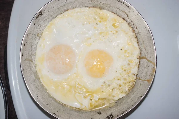 Two fried eggs in a small frying pan — Stock Photo, Image