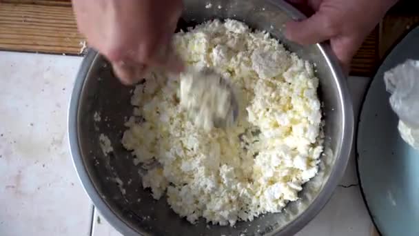 Stirring cottage cheese and egg in a metal bowl — Stock Video