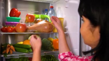 Kadın bir elma ya da et alır.