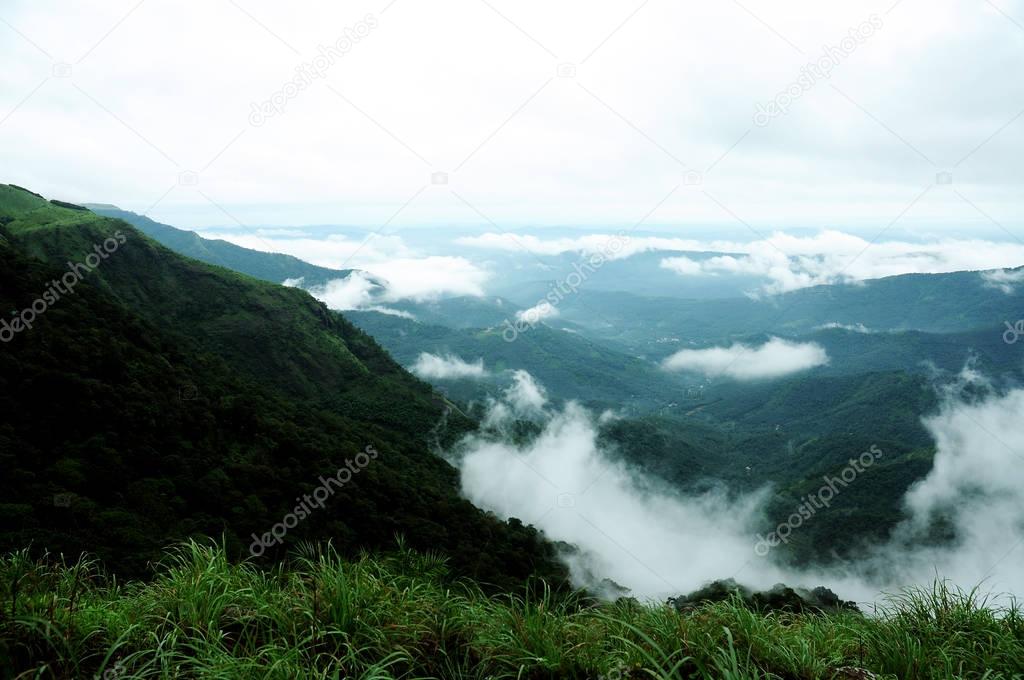 The high mountains tropical forest with clouds passing in India.