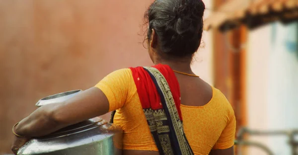 Poor Village woman carrying water pots in South India