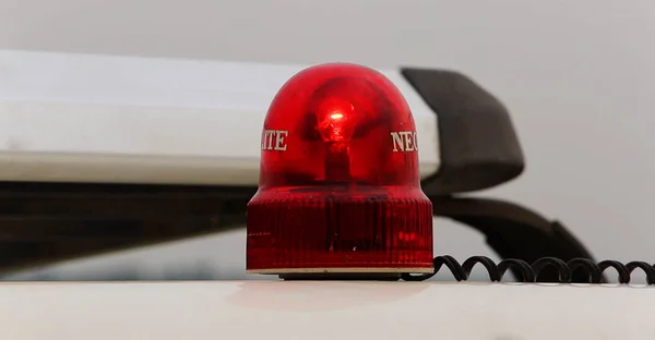 flashing red emergency light that is isolated on white