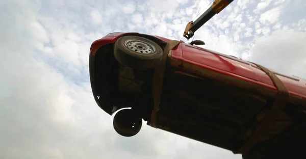 flying car, towing damaged car over a tow truck, low angle shot