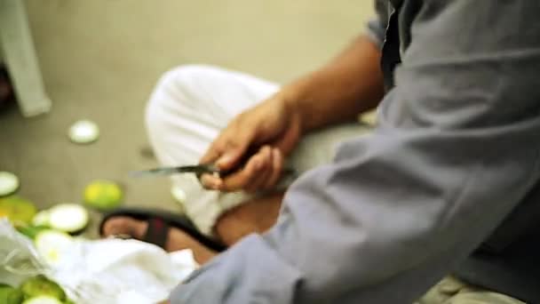 Primer plano joven cortando verduras Mosambi. Boda india preparando cena — Vídeo de stock