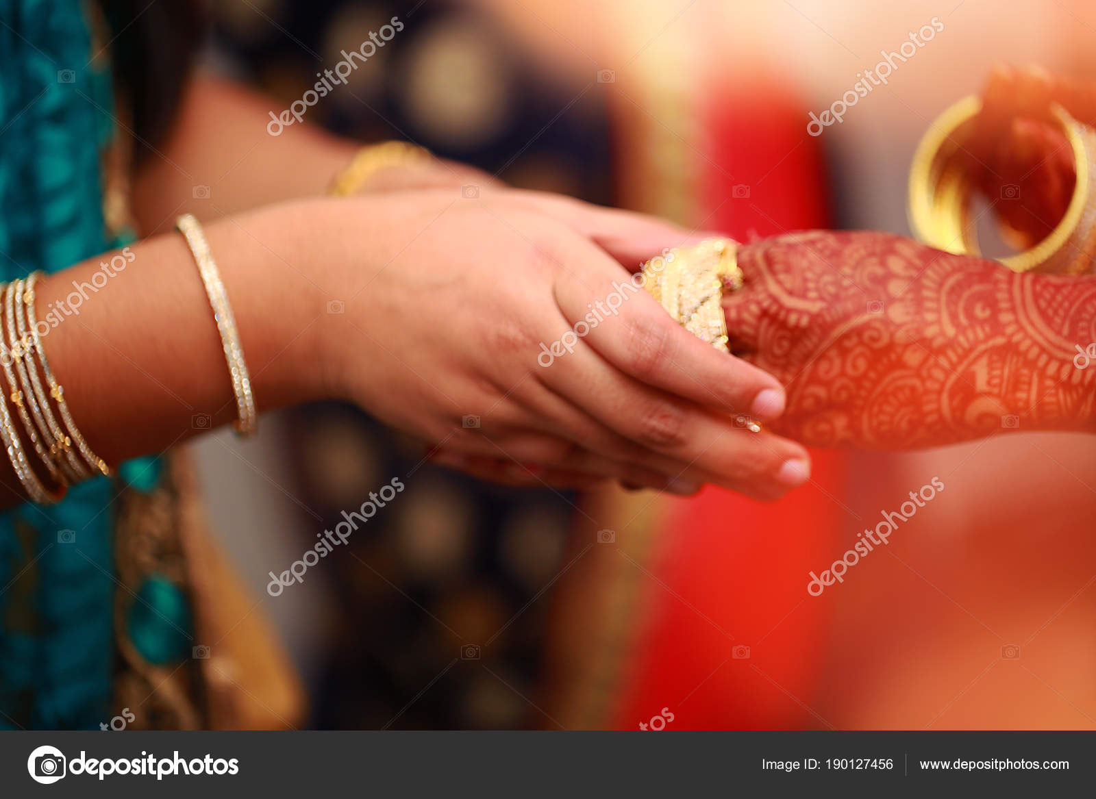 Groom puts bangle in bride hand at bangle ceremony with lights