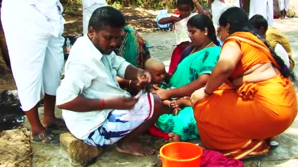 Madurai, indien - 20. April 2017: Ein weinender südasiatischer Junge rasiert sich bei einem Tempelfest den Kopf — Stockvideo