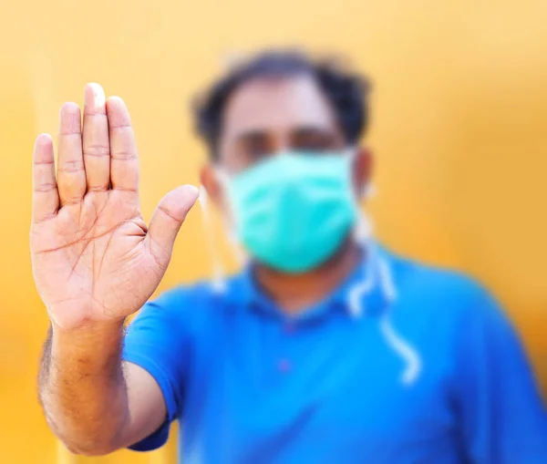 Stop the infection! Healthy man showing gesture \