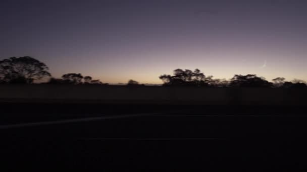 Rörliga landskap ses genom fönstren i ett fordon på natten. En passagerarsidas vy — Stockvideo