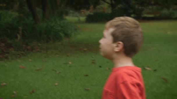 A young boy plays with his mother hitting a balloon back and forth - slowmo — Stock video