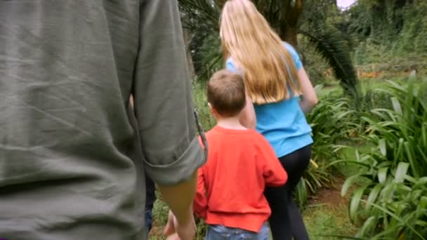 A mother and her kids stop to smell lavender growing in a garden - slowmo — Stock video