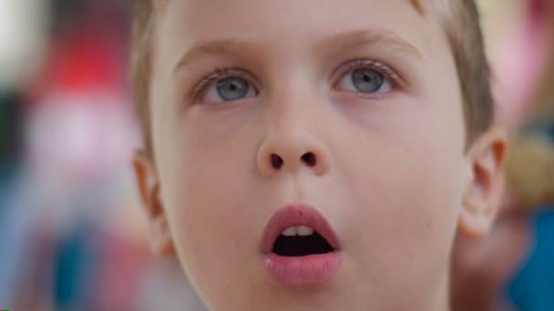 Close up of a cute young boy puffing up his cheeks like he is blowing in Slowmo — Αρχείο Βίντεο