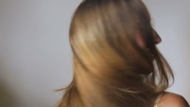 Uma bela jovem mulher com longo cabelo loiro saudável em câmara lenta — Vídeo de Stock