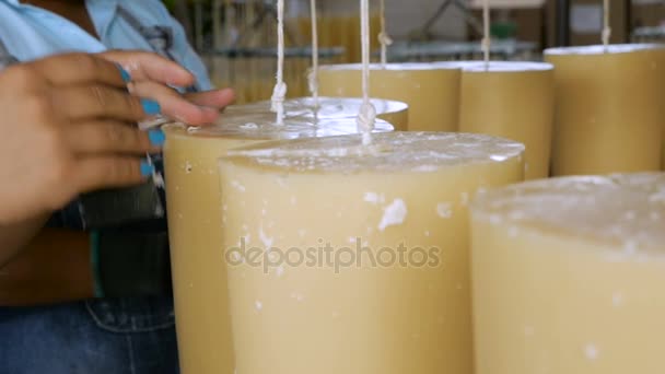 Two workers putting the finishing touches on artisan candles in slow motion — Stock Video