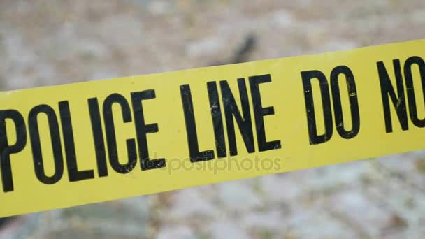 Exterior crime scene tape outside daytime Police Line Do Not Cross dolly shot — Stock Video