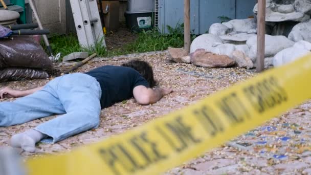 Caucasian white male dead murdered body lying on ground at crime scene — Stock Video