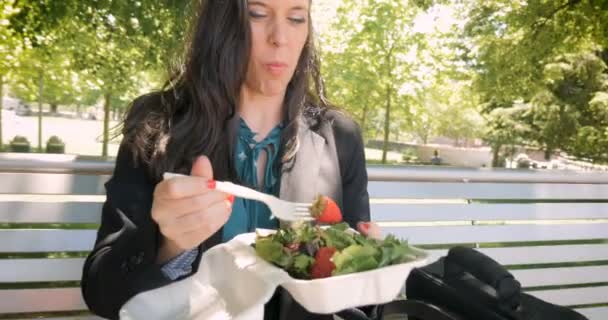 Jonge mooie duizendjarige 30s vrouw gezonde salade buiten eten in 4 k hand gehouden — Stockvideo