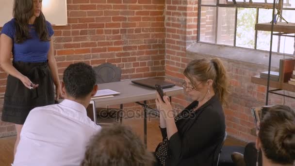 Woman giving a presentation while audience ignores her all using technology — Stock Video