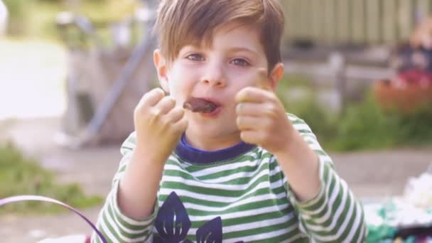 Cute Little Boy Giving Thumbs Up While Enjoying Eating Chocolate